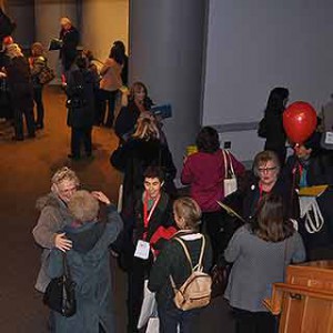Participants gather and chat before the general session.